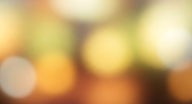 Soft bokeh lights in autumnal hues of yellow orange and brown