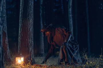 Mysterious figure in plague doctor attire illuminates a dark forest with lantern light.