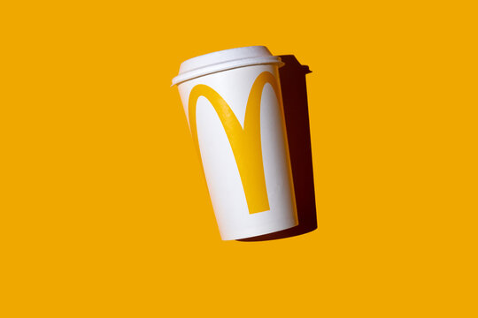 Ukraine, Kyiv - September 18, 2025: Yellow glass of McDonald's. Paper cup takeaway drink top view background. McDonald's logo brand copy space