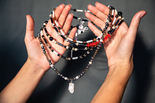 Hands Holding Beaded Jewelry