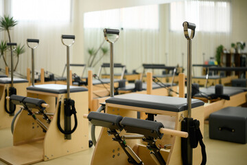 Contemporary fitness studio featuring Pilates machines such as wundar chair and reformer, ideal for...