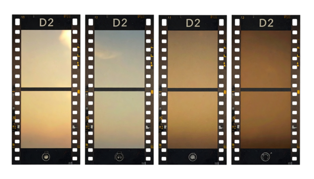 Four different color variations of a landscape image, presented as film frames