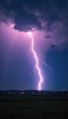 A dramatic, powerful lightning bolt striking a dark, stormy landscape The intense flash illuminates the clouds and the ground below, creating a breathtaking natural phenomenon , powerful, energy