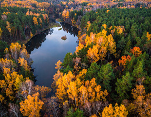 Winding river surrounded by fall foliage, top-down view