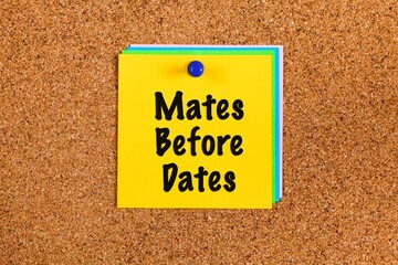 Notes with words Mates Before Dates on cork board