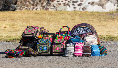 Teotihuacan, Mexico - 1 December 2022: Local colorful hand-embroidered backpacks  with traditional decorations sold near pyramids of Teotihuacan
