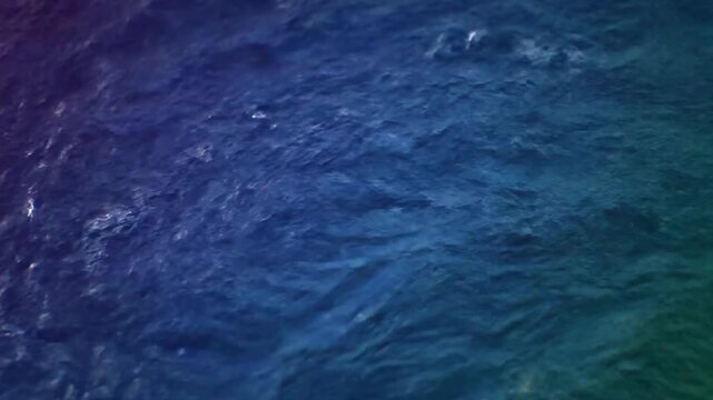 Abstract Blue Fluid Turbulence Loop Background. Dark Blue Water Surface with Ripples and Swirls. Dynamic Liquid Motion. Seamless Loop