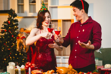 A cheerful group of diverse friends gathers around a decorated Christmas tree, exchanging gifts with laughter and joy at a festive holiday party.