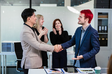 Diverse business team collaborates in modern office, discussing charts, data, strategies. Their professional teamwork reflects communication, leadership, success, productive, innovation cooperation.