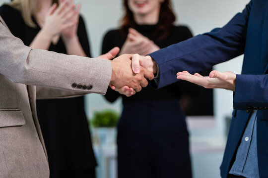Diverse business team collaborates in modern office, discussing charts, data, strategies. Their professional teamwork reflects communication, leadership, success, productive, innovation cooperation.