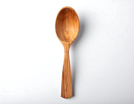 A light brown wooden spoon against a white background