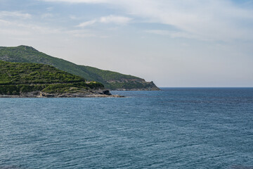 Fototapeta premium Village beach view Roadtrip Winding road along rocky coast of Cap Corse peninsula on Corsica island France