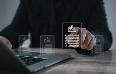 Hand selecting digital document with house icon on laptop screen. Concept of property management, real estate contract, housing application, mortgage, and online document verification system.
