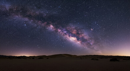 The Milky Way galaxy arcs majestically across a star-filled night sky above a serene desert...