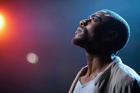 Actor preparing for a performance on stage, experiencing the fear of failure under colorful lights - Powered by Adobe