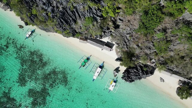 Coron, Palawa, Philippines, in South East Asia, with White Sand Beach, Turquoise Water, filmed on an Island island hopping boat tour with Limestone Cliffs in the background
