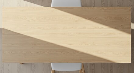 Overhead view of a light wooden table with a diagonal shadow and two white chairs on a light floor, creating a minimalist scene.