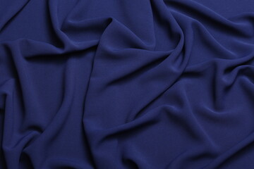 Soft lightweight flowy georgette fabric in navy blue, elegantly draped with natural folds. Perfect for fashion design, textiles, sewing, dressmaking, and delicate feminine style concepts.