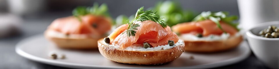 Freshly made bagel with cream cheese and smoked salmon served with capers and herbs