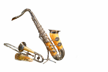 Unique brass saxophone and trumpet displayed against white background showcasing musical artistry and craftsmanship