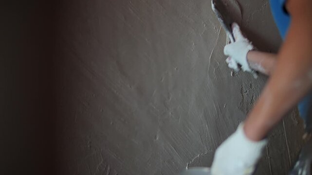 Worker Smoothing Fresh Plaster on Wall with Trowel