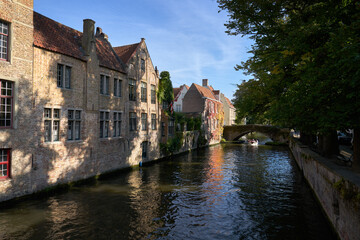 Bruges, Belgium – September 14, 2024 Tourist Cruise Boat under Peerdenstraat Bridge Bruges. Scenic tourist canal tour on the Groenerei canal under the Peerdenstraat Bridge. Bruges, Belgium.
