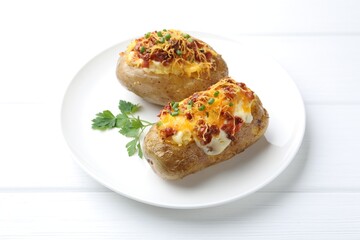 Tasty stuffed baked potatoes on white wooden table, closeup