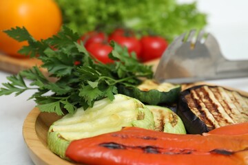Tasty grilled vegetables and other food products on table, closeup