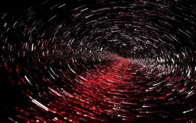 A mesmerizing tunnel of red and white light streaks creating a spiral effect