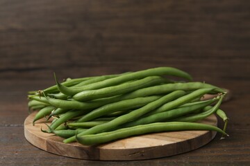 Fresh green bean pods on wooden table, closeup