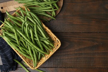 Fresh green bean pods on wooden table, flat lay. Space for text