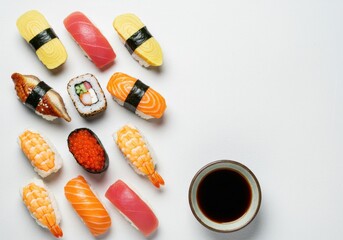 A vibrant mix of nigiri and sushi rolls with a soy sauce bowl on a white background with copy space
