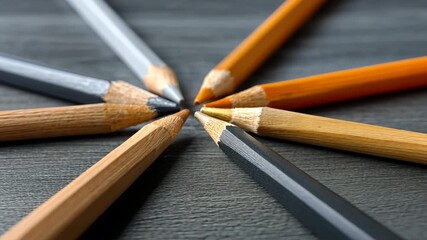 Different colors of pencils arranged in a circle on a dark surface create a striking visual display of art supplies - Powered by Adobe