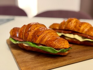 croissants with cheese and ham on the kitchen table. High quality photo