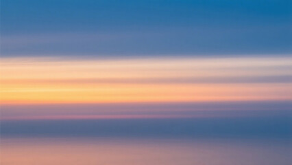 Obraz premium Horizontal bands of color in the sky during sunset with hues of blue orange and purple blending together