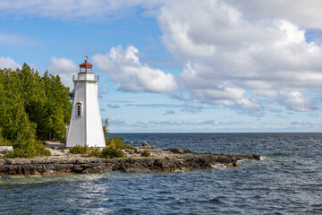 Big Tub Harbour Lighthouse stands tall in Tobermory, Ontario, overlooking the pristine waters of Georgian Bay.