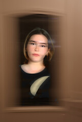 A young woman in a doorway closeup with ICM motion blur  and glitch effect abstract art