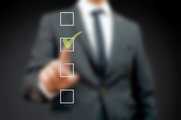 Business man with checklist and to do list. Man writing and drawing v sign check marks with hand...