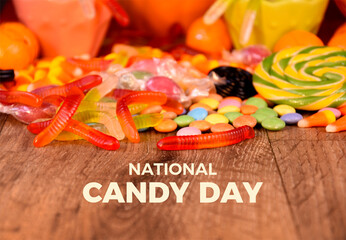 National Candy Day poster stock photo images. Colorful candies and jelly worms on wooden background. Template for background, banner, card. November 4. Important day