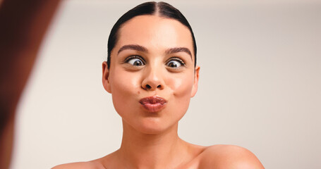 Portrait, funny or influencer in studio with selfie, skincare and cosmetic for social media. Meme, content creation or woman in fashion with makeup, online or wellness in space for advertising.