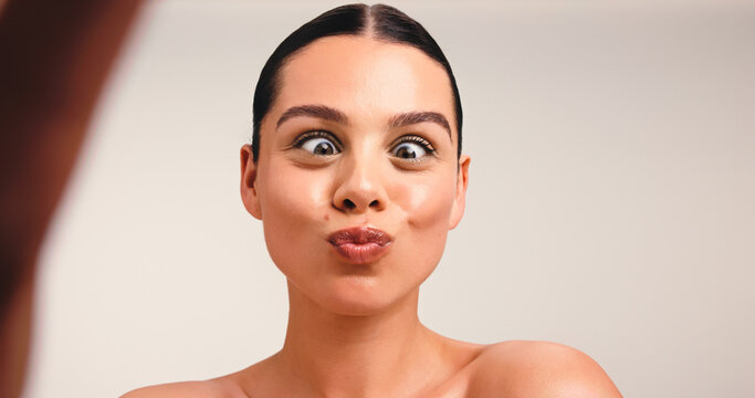 Portrait, funny or influencer in studio with selfie, skincare and cosmetic for social media. Meme, content creation or woman in fashion with makeup, online or wellness in space for advertising.