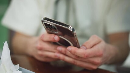 Closeup view of fresh fingers scrolling on phone screen, soft blur background, rapid touch interaction showing app content, natural skin detail and movement, modern mobile use from top angle