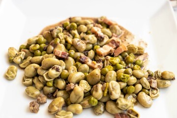 Fresh Broad beans Catalan style with ham and bacon, a healthy and nutritious complement to any meal. Well-being and healthy food