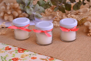 Candles autumn wedding favors white glass jars orange color ribbon fall season small guest gifts jute eucaliptus background, home party decoration, craft rustic souvenirs