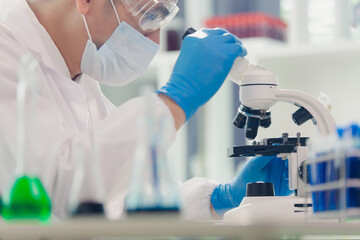 medical or scientific researcher researching and experimenting Multi-colored solution, vial and...