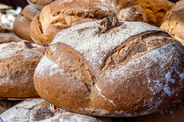 A close-up of a freshly baked loaf of whole grain rye bread from a local store. Its inviting aroma promotes healthy eating and well being.