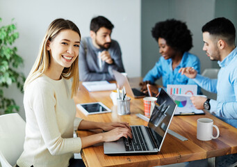 Portrait of a group of young business people having a meeting in the office. Teamwork and success concept, portrait of a smart young businesswoman