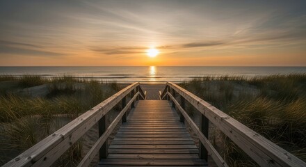Fototapeta premium Wooden Boardwalk Leads Towards a Golden Ocean Sunset