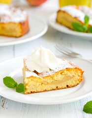Slice of apple cake with whipped cream