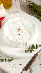 Round cheese with herbs and spices
